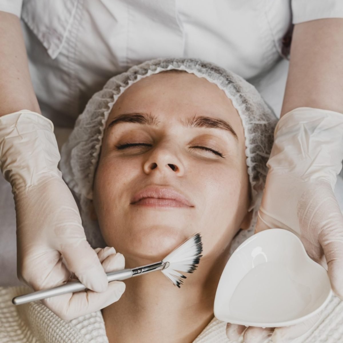 top-view-young-beautiful-woman-getting-face-skin-treatment